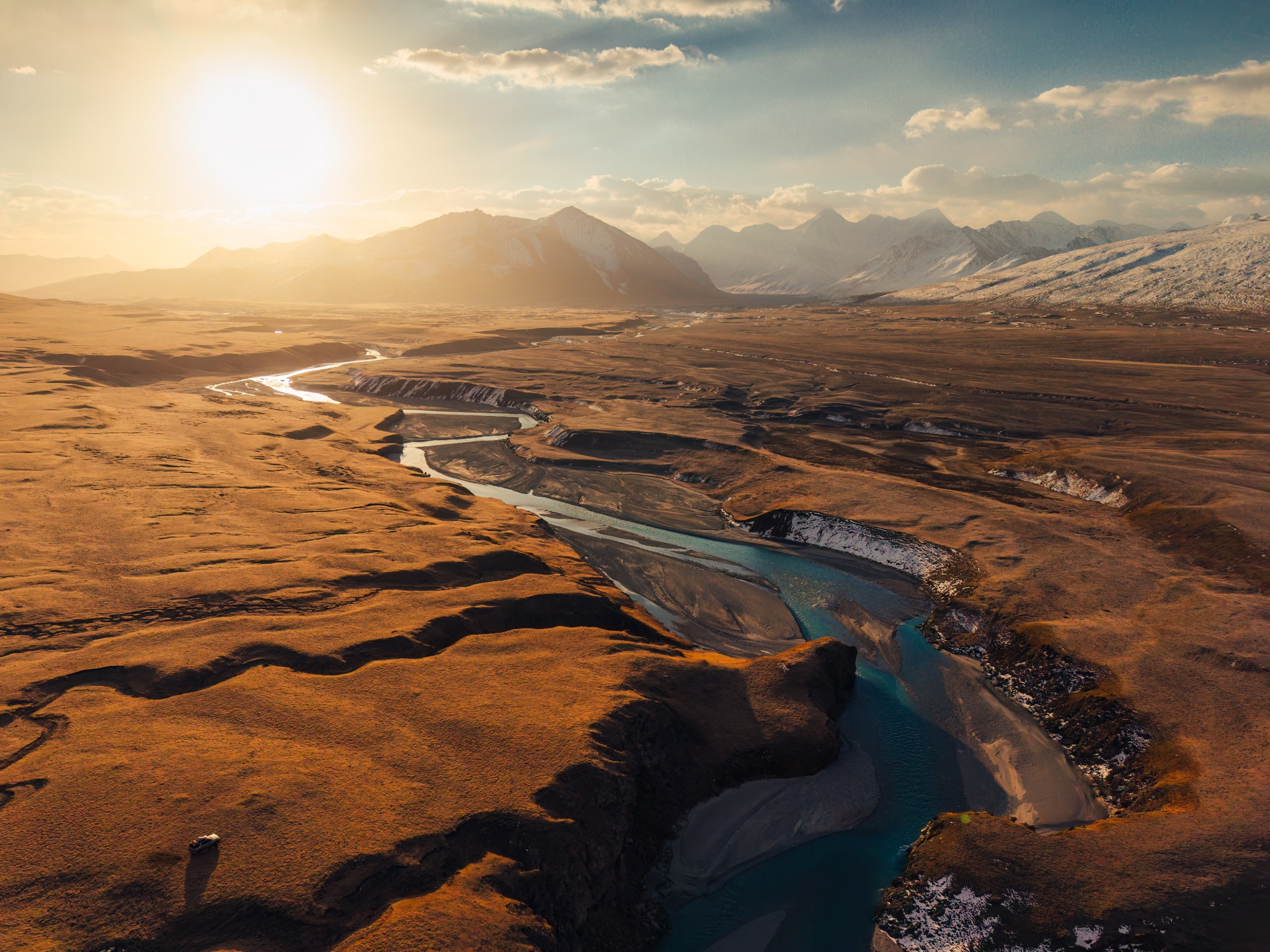 River channels winding through a sunlit valley