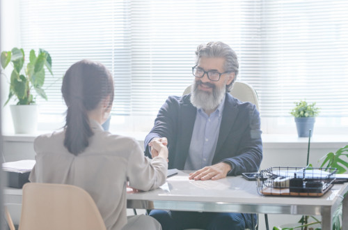 Businessman shaking hand with Business Woman
