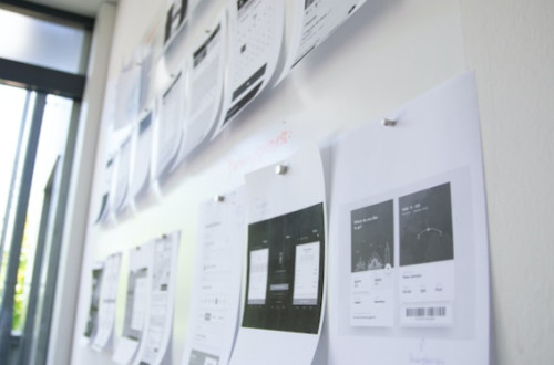 website screenshots printed on whiteboard